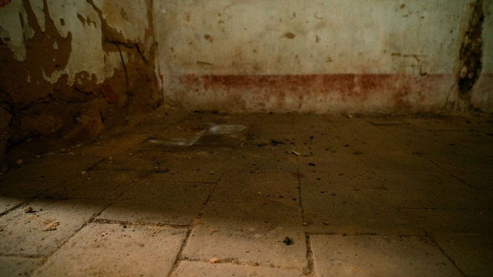 Piso de ladrilho original e rodapé desgastado